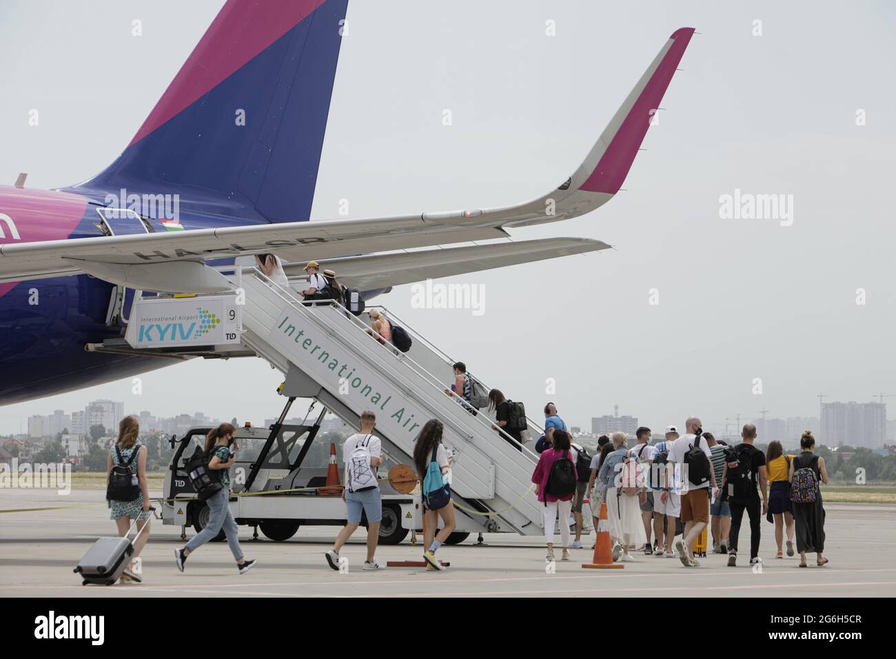 KYIV, UKRAINE - JUNE 24, 2021 - Passengers board a plane on the airfield at the Igor Sikorsky Kyiv International Airport (Zhuliany), Kyiv, capital of Stock Photo