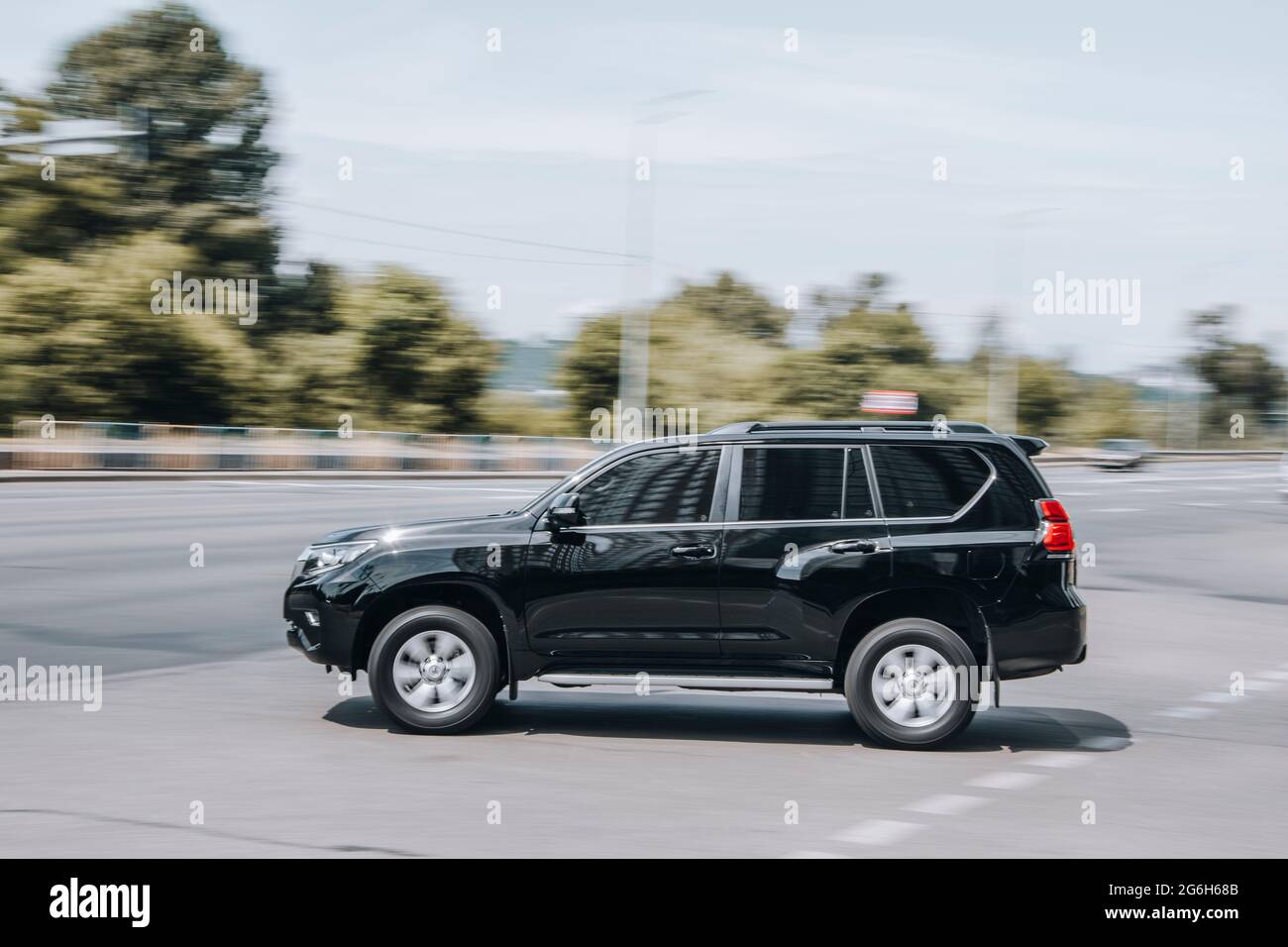 Ukraine, Kyiv - 27 June 2021: Black Toyota Land Cruiser Prado car moving on the street. Editorial Stock Photo