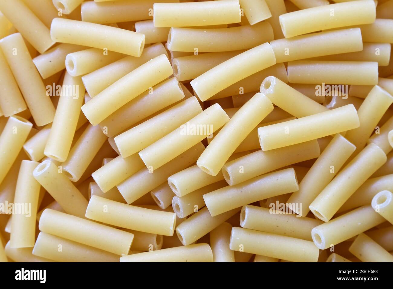 Pasta formed into tubes to make macaroni. Stock Photo