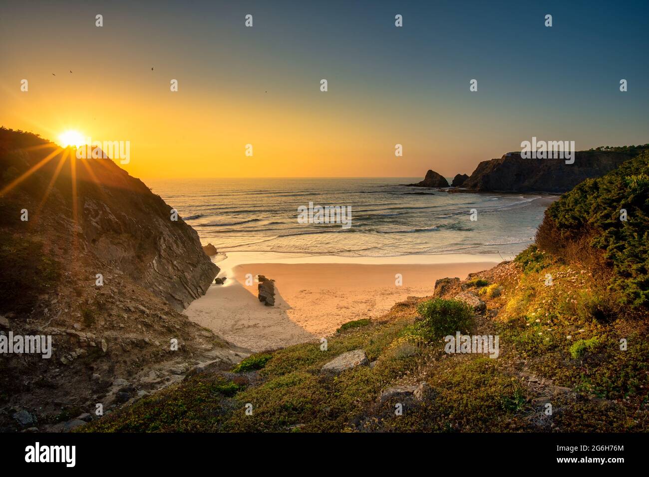 Landscape with sunset over Portuguese West coast and sandy Praia de Odeceixe Stock Photo