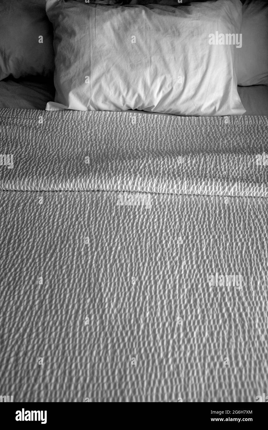 Clean bed bedding and pillows with white sheets for comfort sleeping