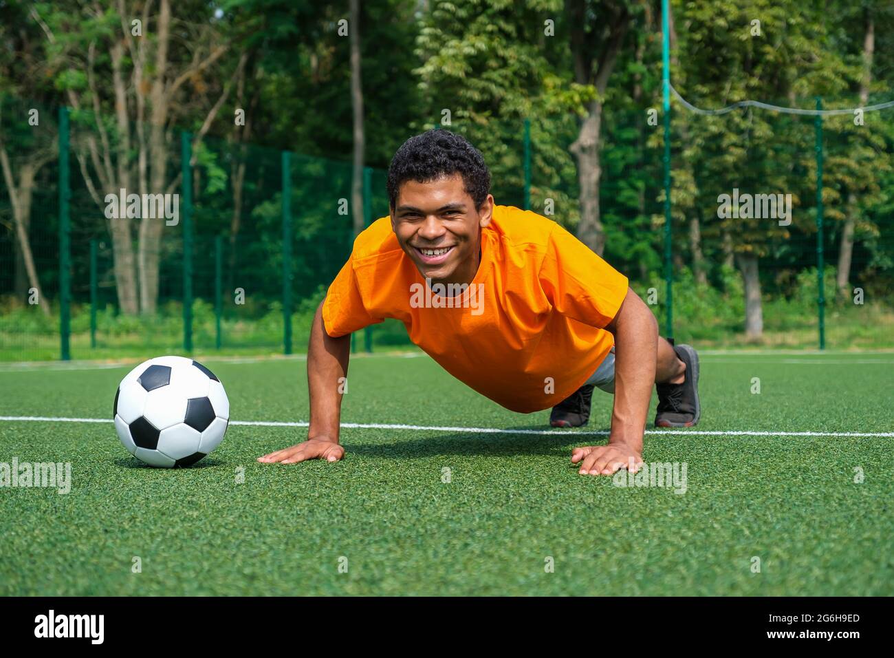 Spanish footballer warms up on training on the sport ground in summer Stock Photo
