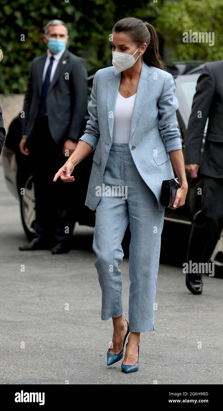 Madrid, Spain; 06.07.2021.- For an event organized by Abertis and Unicef, Queen Letizia debuts working look a blue linen suit by Adolfo Domínguez perfect for high temperatures, consisting of capri pants and a long blazer with a single button, which was unbuttoned and with the sleeves rolled up She has combined it with a simple white top, a basic with a V-neckline, shoes that combine skin and snakeskin in navy blue and a matching bag. As for jewelery, the hoop earrings in white gold, diamonds and aquamarines from Bulgari. Karen Hallam's ring. The working meeting with members of the management t Stock Photo