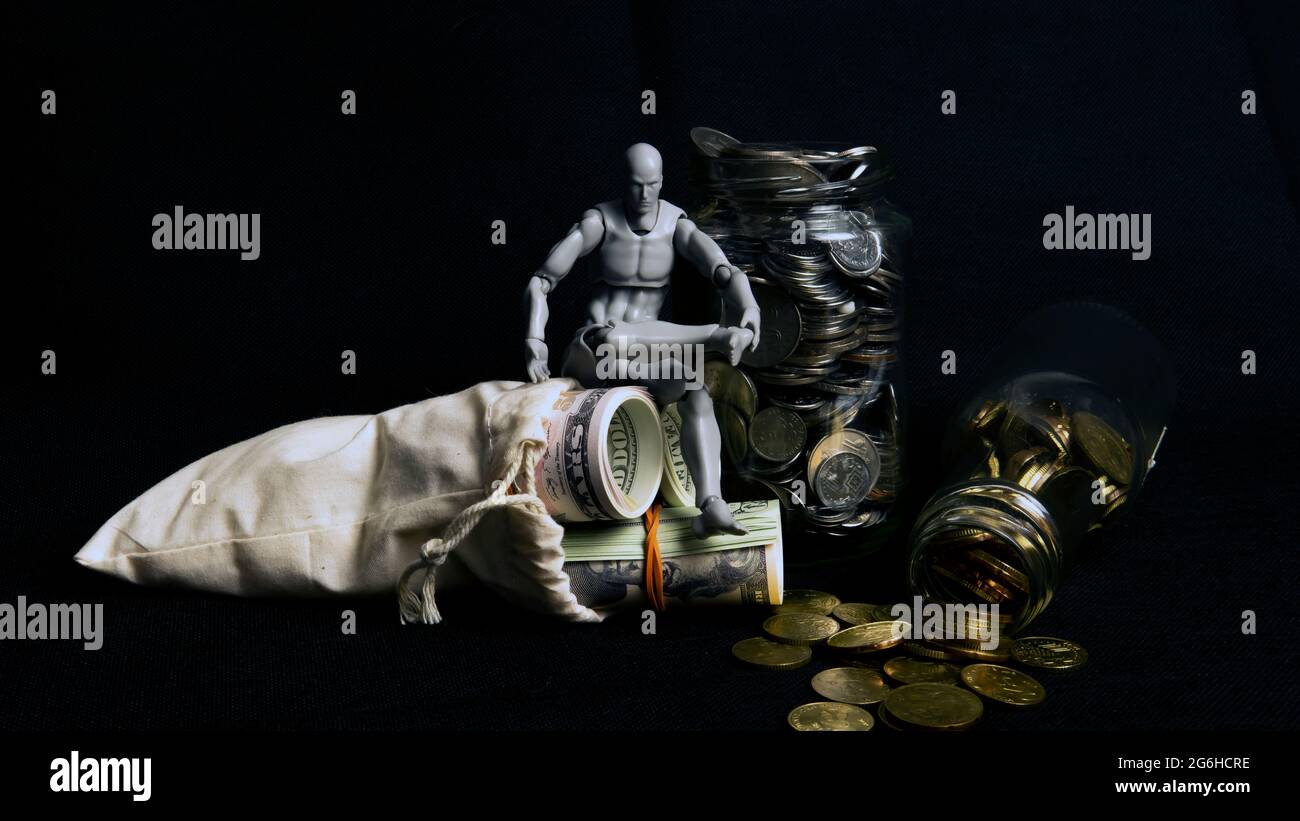 Saving Concept. Selective focus on the money and coins isolated on black background Stock Photo