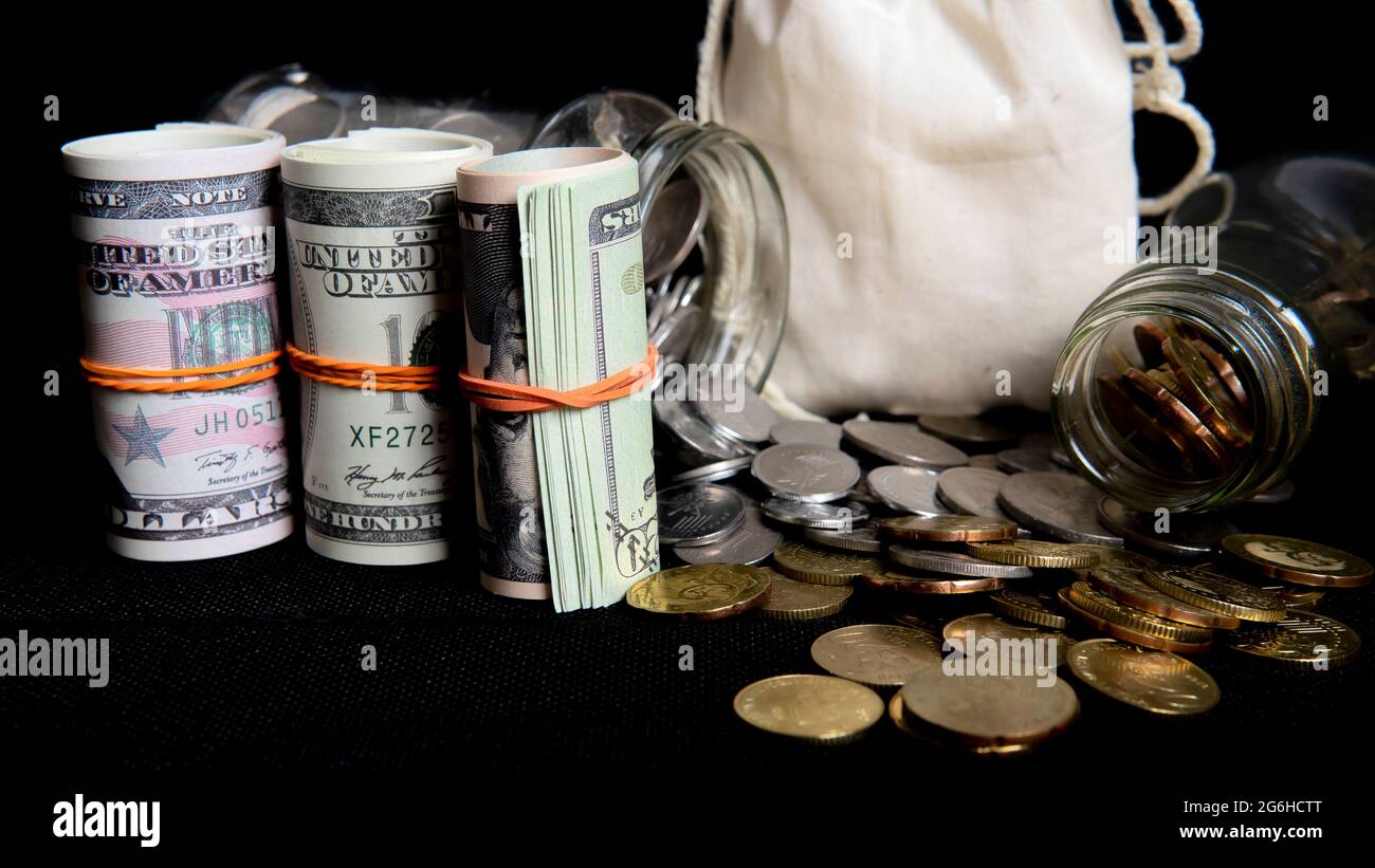 Saving Concept. Selective focus on the money and coins isolated on black background Stock Photo