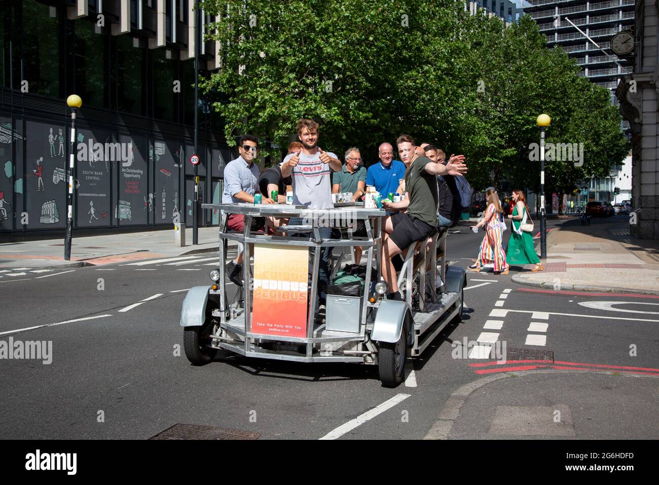 People enjoying the sunshine on a Pedibus, also called a beer bike in Central London. Stock Photo