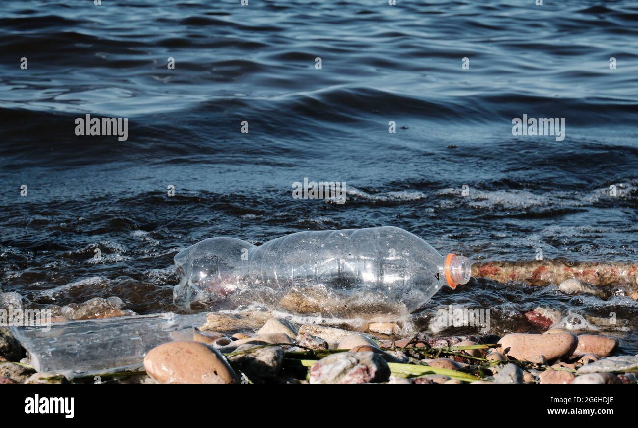 A plastic bottle floats in the water. The problem of pollution of the