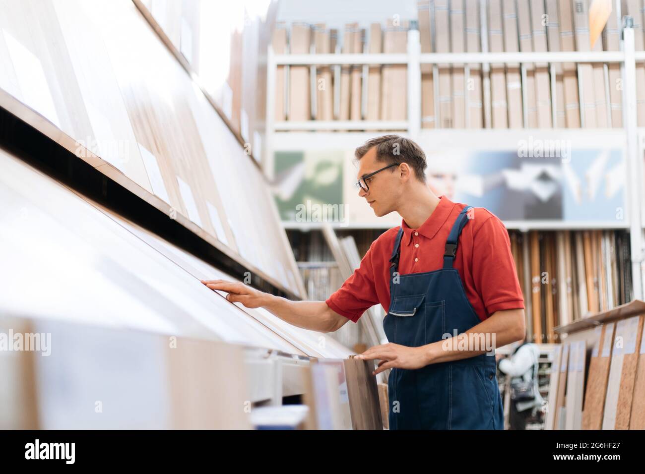 sales consultant inspecting samples of floor coverings. Stock Photo