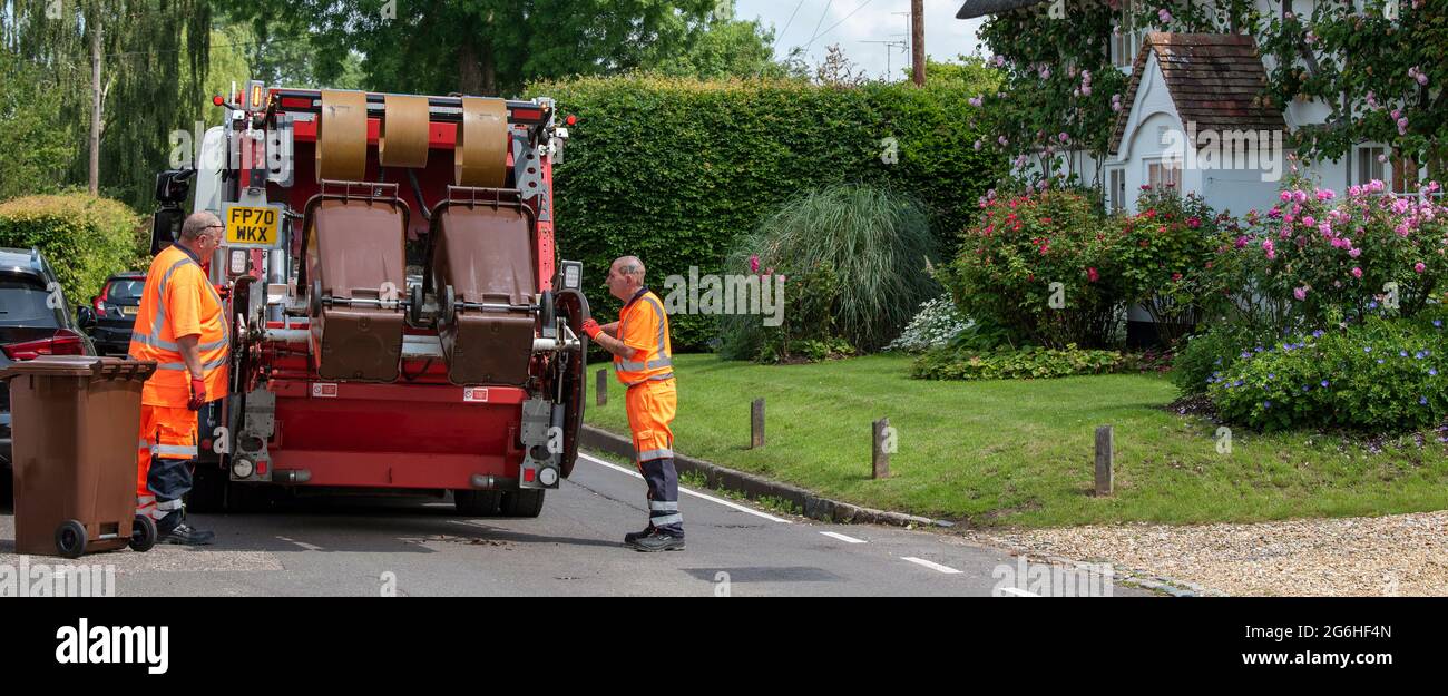 Hampshire, England, UK. 2021. Council operatives collect garden waste