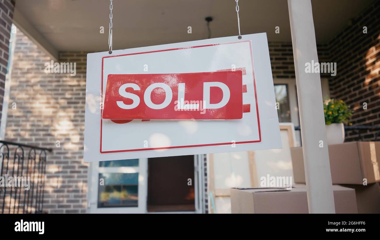 red sticky label with sold lettering on board near new house Stock ...