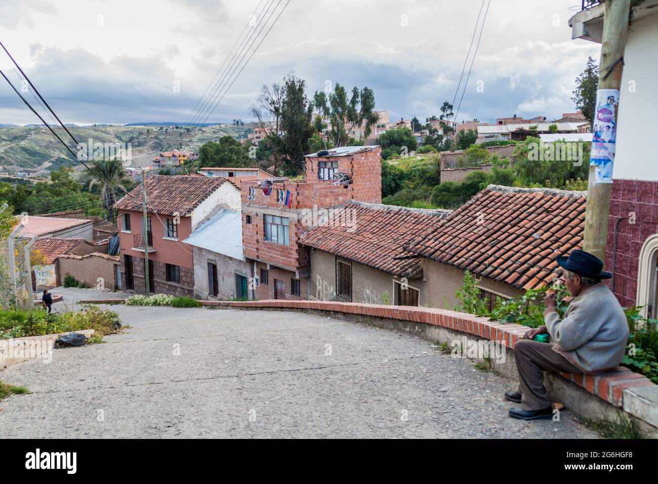 SUCRE, BOLIVIA - APRIL 21, 2015: Local man sits on a street in Sucre, Bolivia Stock Photo