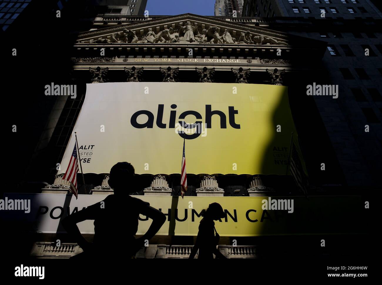 New York, United States. 06th July, 2021. The Fearless Girl statue faces a banner with the Alight Solutions logo on it at the New York Stock at the NYSE on Wall Street in New York City on Tuesday, July 6, 2021. The Dow began the day down 350 points and is in position to break a 7-day streak of gains. Alight Solutions will begin trading today at the New York Stock Exchange under the stock symbol 'ALIT.' Photo by John Angelillo/UPI Credit: UPI/Alamy Live News Stock Photo