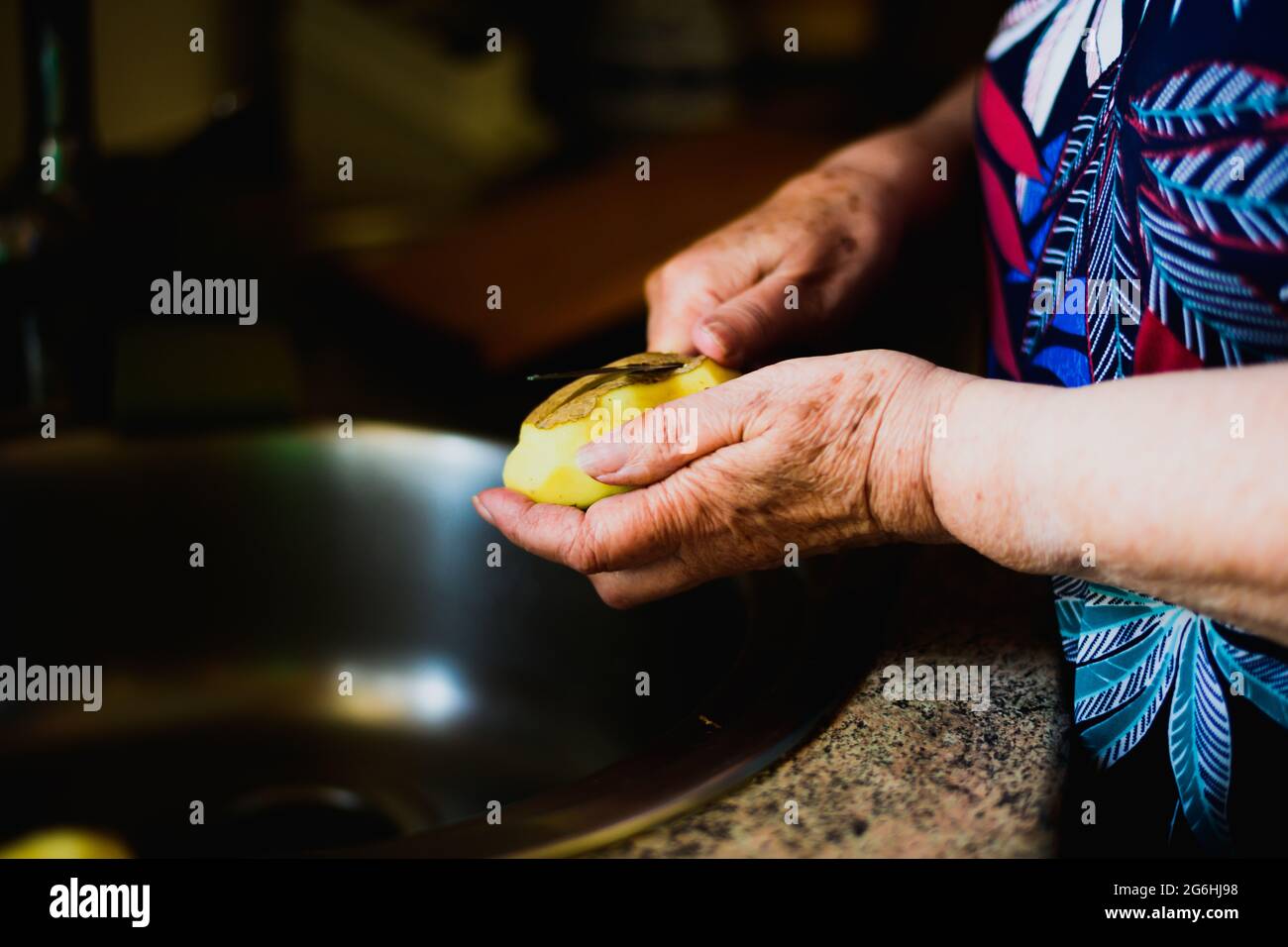 Woman peeling potatoes hi-res stock photography and images - Alamy