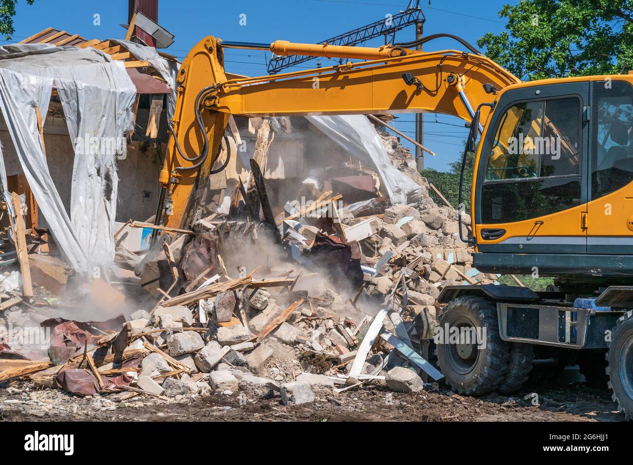 Hydraulic Excavator Breaks House. Building Demolition or Destruction