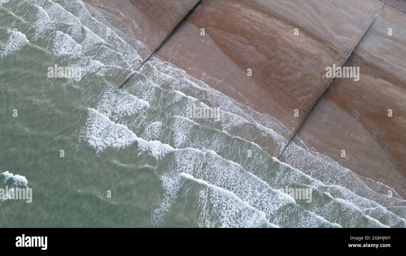 Overhead aerial shot Waves breaking on single beach at Eastbourne Sussex Stock Photo