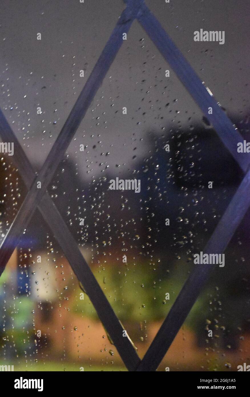 Raindrops on a leaded window pane. Stock Photo