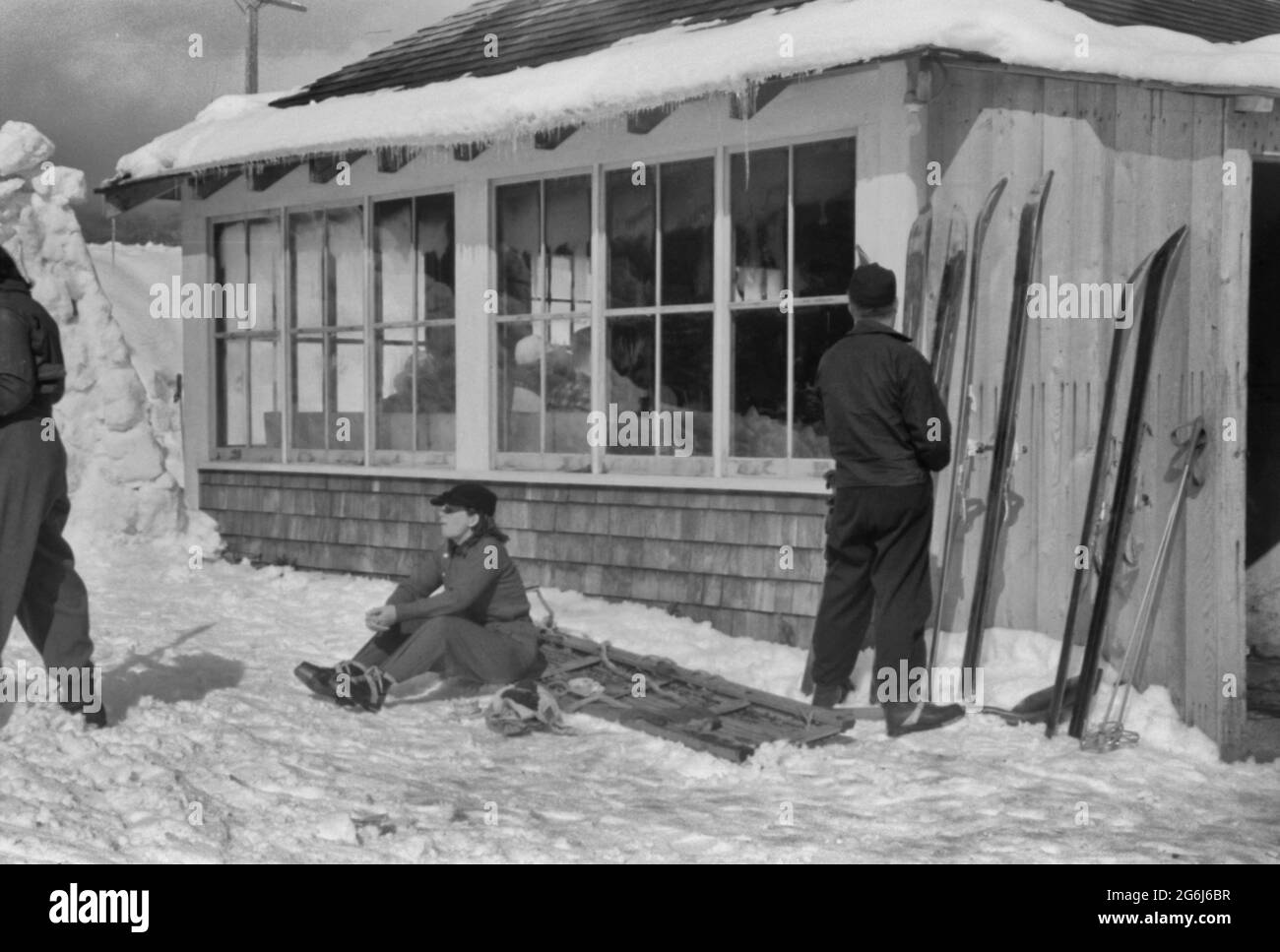 Skiers outside of Tollhouse at foot of Mount Mansfield, Smugglers Notch. Near Stowe, Vermont, circa 1940 Stock Photo