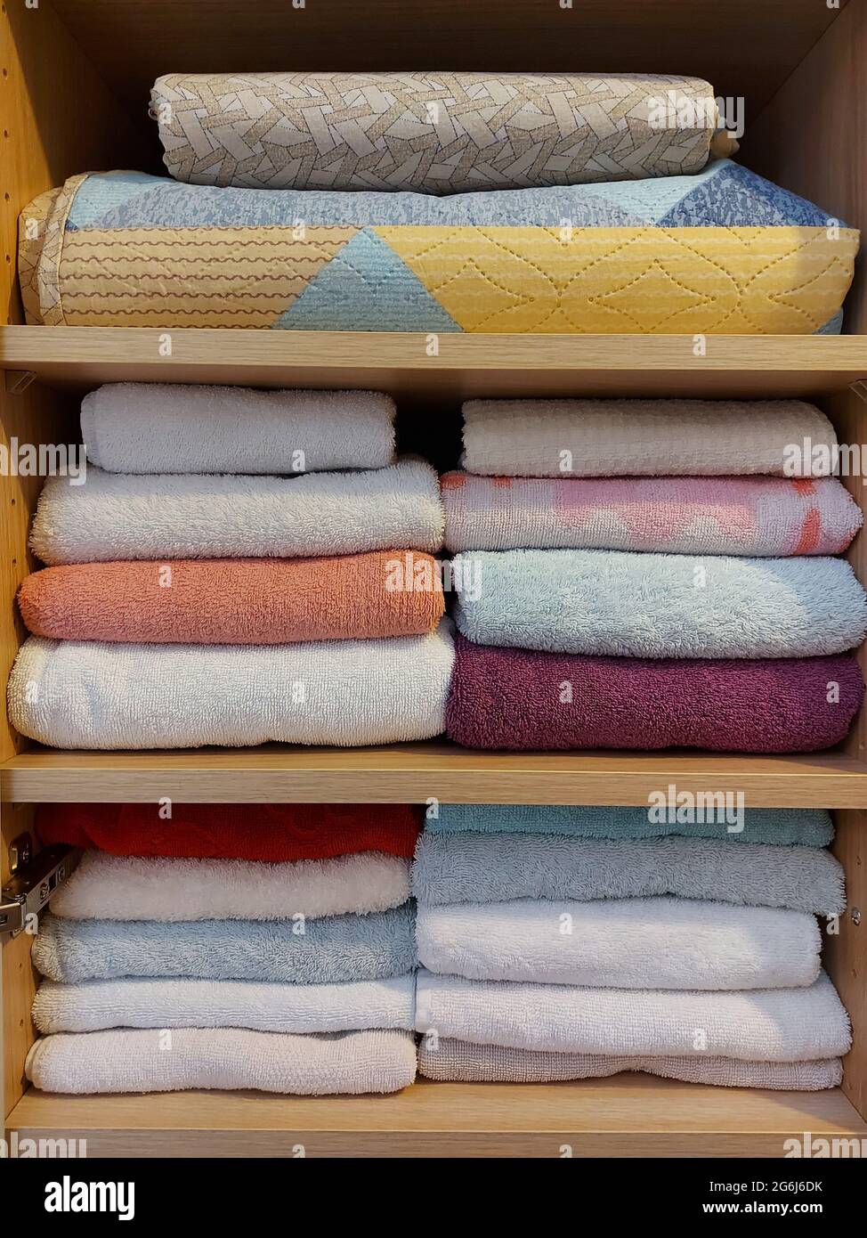 Multi-colored cotton terry towels are stacked Stock Photo
