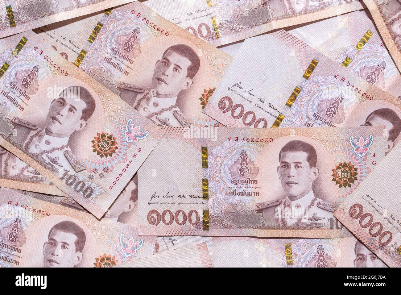 Baht banknotes background. global financial crisis concept. Background of the one thousand baht bills. Many thousand Thai baht banknotes stacked on to Stock Photo