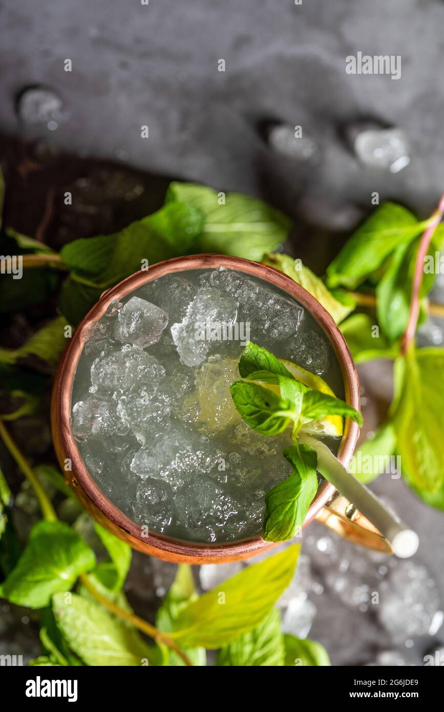 Moscow mule cocktail in copper cup with lime, ginger beer, vodka and mint garnish Stock Photo