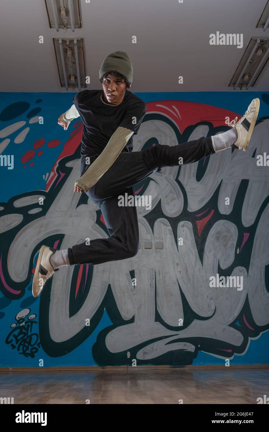 Modern rapper dancing in garage. Urban lifestyle, hip hop Stock Photo ...