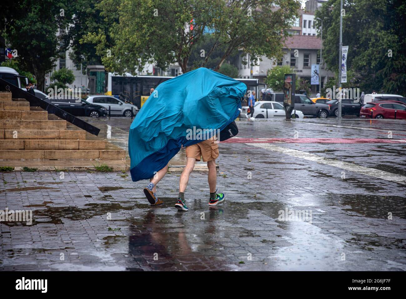 Istanbul, Turkey. 06th July, 2021. A couple sheltering from the rains in  Kadikoy that had a negative impact on life. Credit: SOPA Images  Limited/Alamy Live News Stock Photo - Alamy