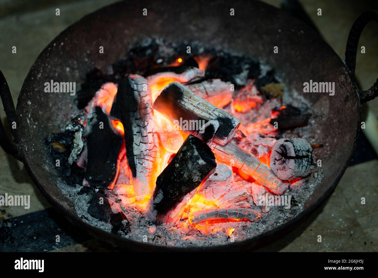 Burning charcoal in an iron stove for home heating. Red burnt charcoal and ashes to warm the room Stock Photo Alamy