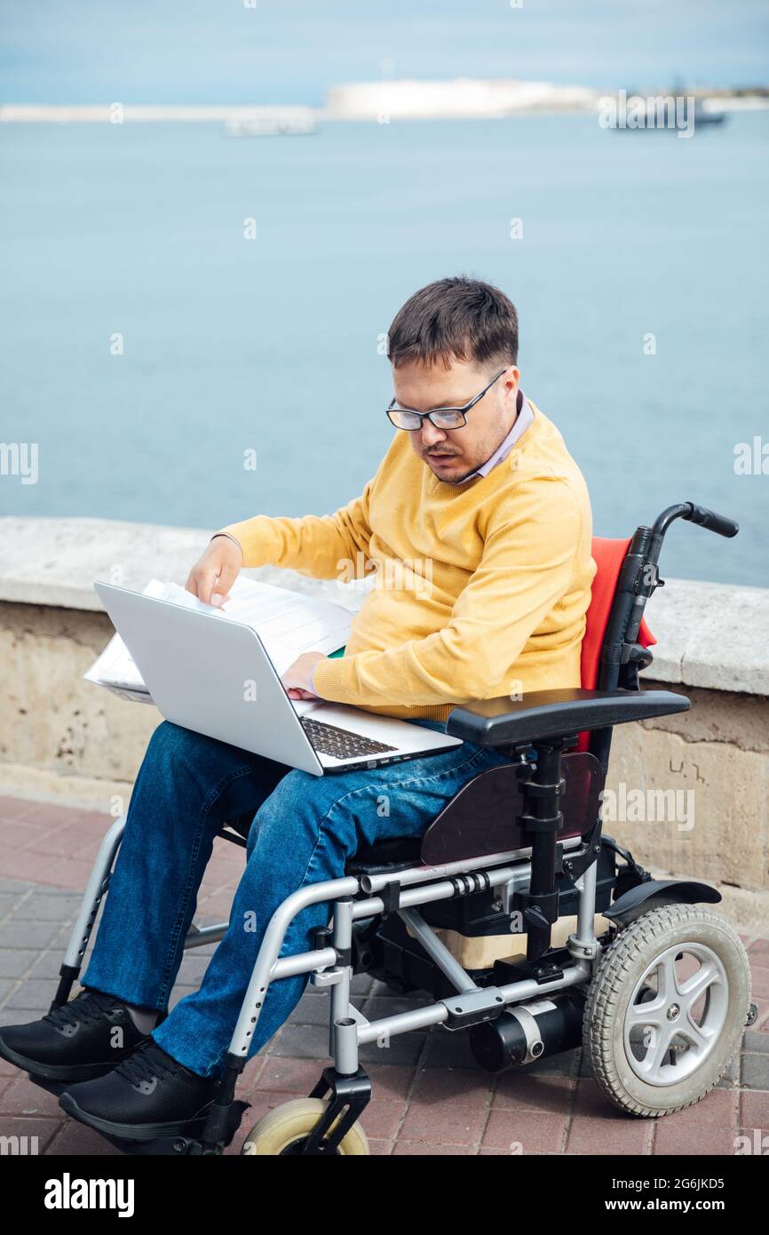 man with disabilities in wheelchair job business community Stock Photo