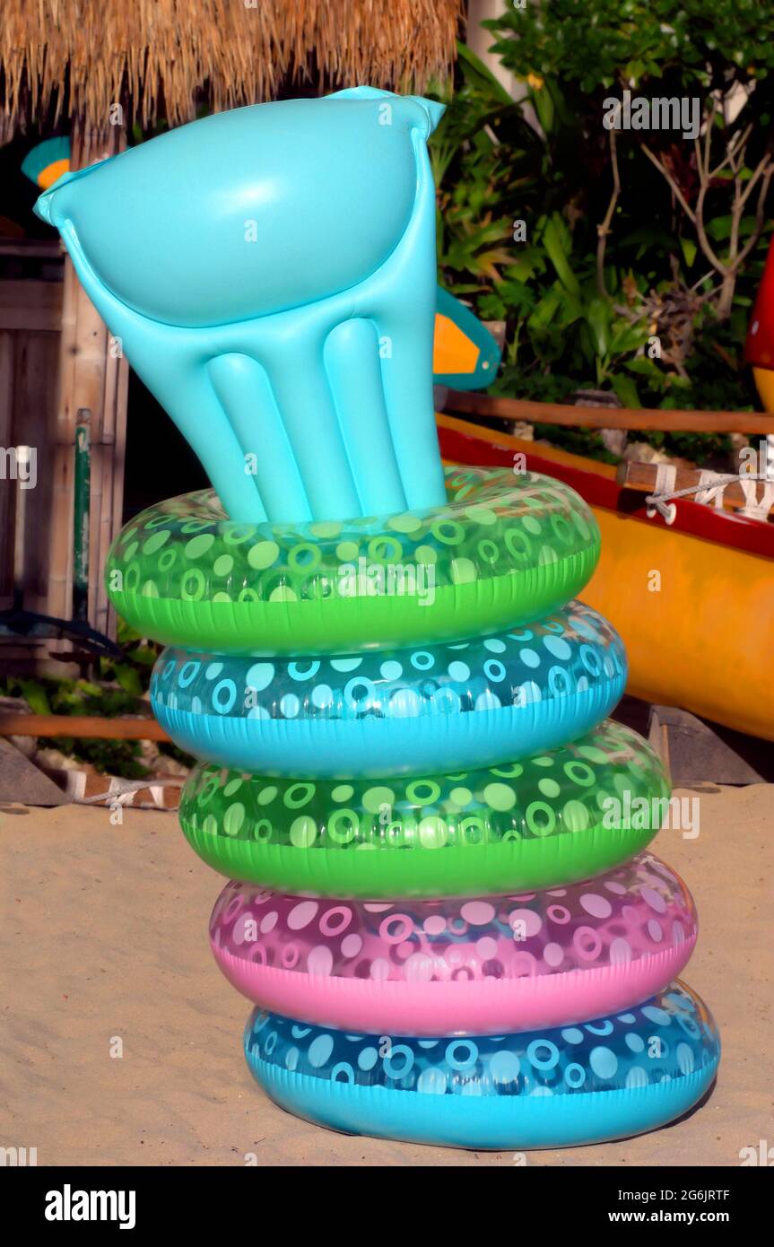 Colorful swimming rings are organized and held in place by sticking an