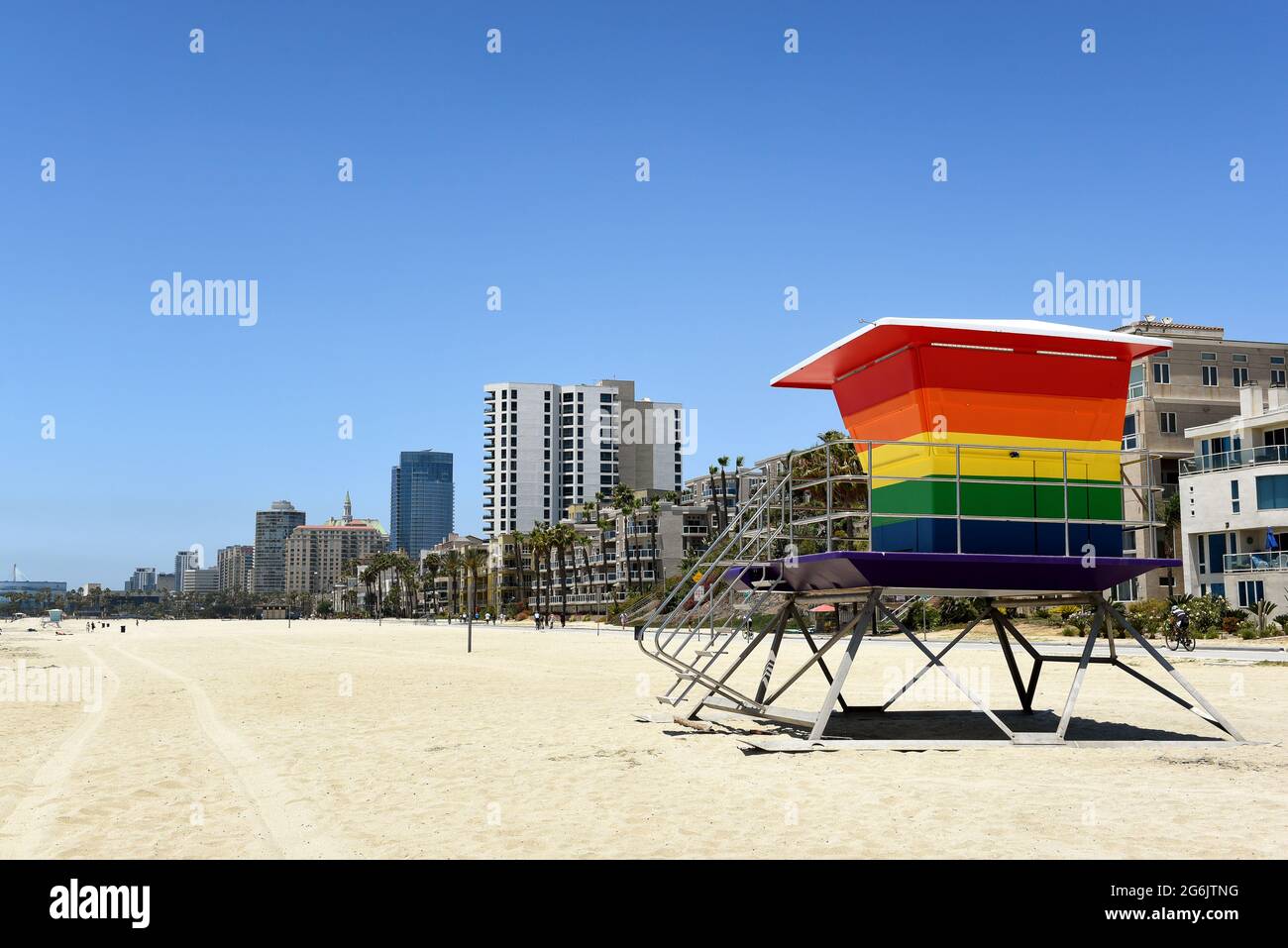 LONG BEACH, CALIF - 5 JUL 2021: Pride Tower, at Shoreline Way and 12th Pl, with the city skyline in the background. The rainbow-colored lifeguard towe Stock Photo