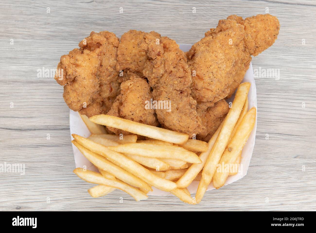 Overhead view of deep fried meal of strips of breaded chicken and a
