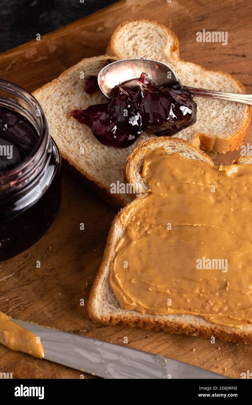 https://c8.alamy.com/comp/2G6JWNE/fixing-a-peanut-butter-and-jelly-sandwich-on-a-wooden-kitchen-counter-2G6JWNE.jpg