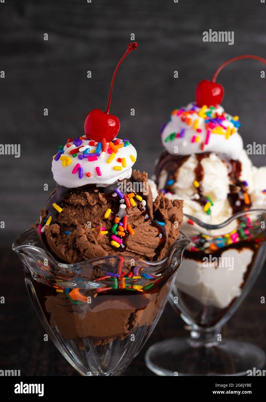 Chocolate and Vanilla Ice Cream Sundaes in Classic Glass Bowls Stock