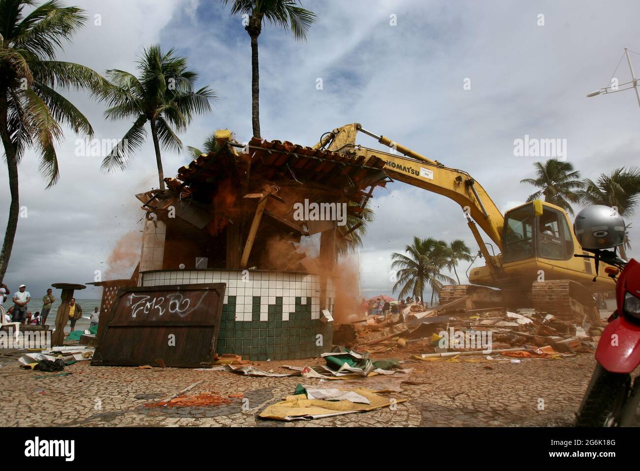 salvador, bahia, brazil - july 15, 2014: Reotro-excavator machine makes demolition of kiosk on the sidewalk of Itapua beach in Salvador. The demolitio Stock Photo