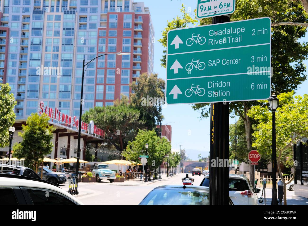 Bike direction sign in downtown San Jose, California to SAP Center, Guadalupe River Trail, and Diridon Station with distance measured in minutes. Stock Photo