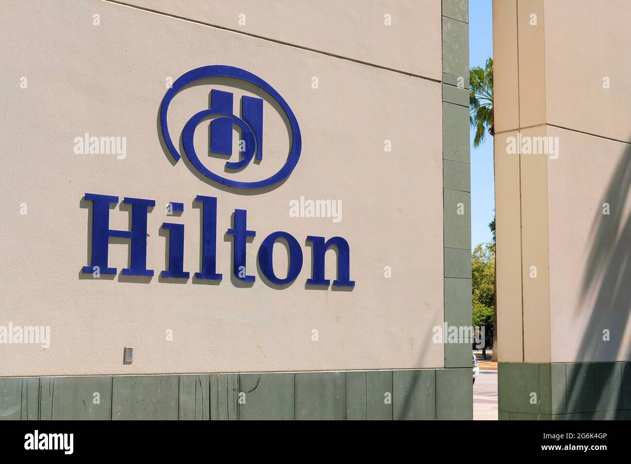 Exterior Hilton sign and logo near the entrance of the downtown San Jose, California hotel building. Stock Photo
