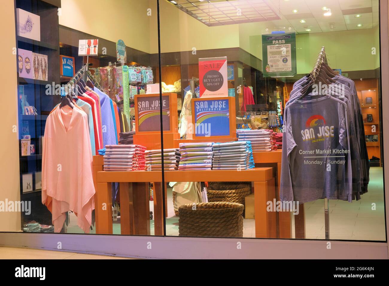 Window display at a gift store in San Jose, California showcasing shirts and sweatshirts with the name of the city for tourists to purchase; tourism. Stock Photo