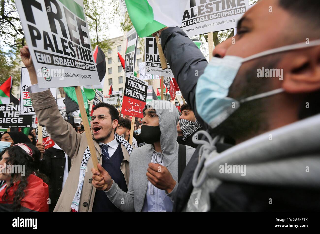 London, UK. 11th May, 2021. Protesters hold placards expressing their opinion during the demonstration. Pro Palestinian protesters gather outside Downing Street to protest against Palestinian families being evicted from their homes by Jewish settlers in the Sheikh Jarrah district of East Jerusalem. The protesters are also demonstrating about Israeli bombing of civilians in Gaza. (Photo by Martin Pope/SOPA Images/Sipa USA) Credit: Sipa USA/Alamy Live News Stock Photo