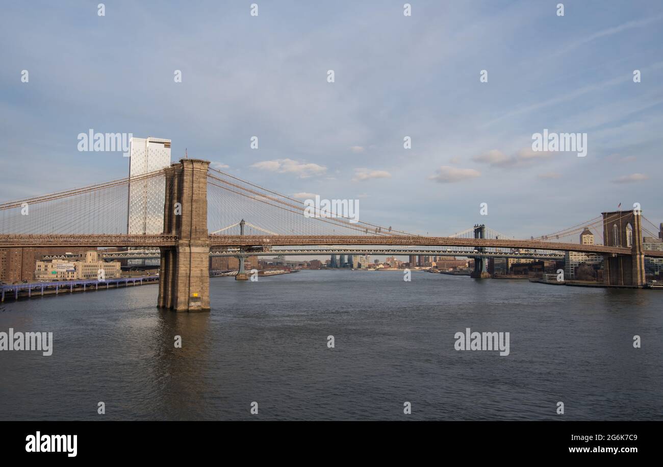 Brooklyn Bridge in New york City, Manhattan with water view and cloudy sky Stock Photo