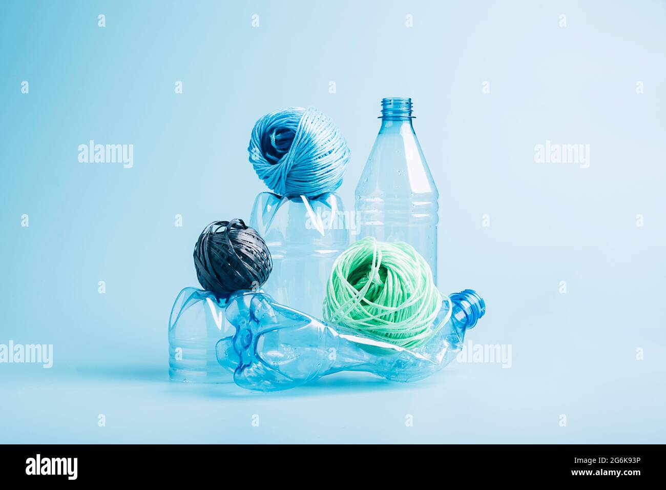 Plastic recycling and reuse concept. Empty plastic bottle and polyester ...
