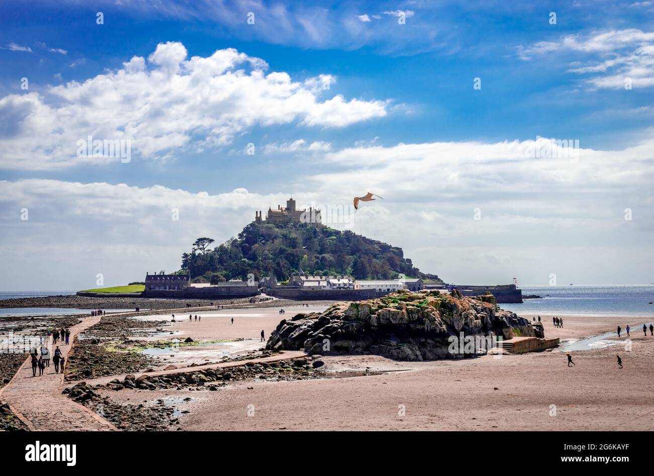 View of the island with the castle on the hill. St Michael's Mount is a tidal island in Mount's Bay, Cornwall, accessible by foot on low tide. Stock Photo