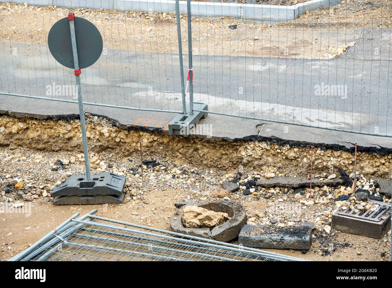 the road is being renewed, construction work is underway. Obstacles hinder the pedestrians and motorists. the pavement is torn up, stones and dirt Stock Photo