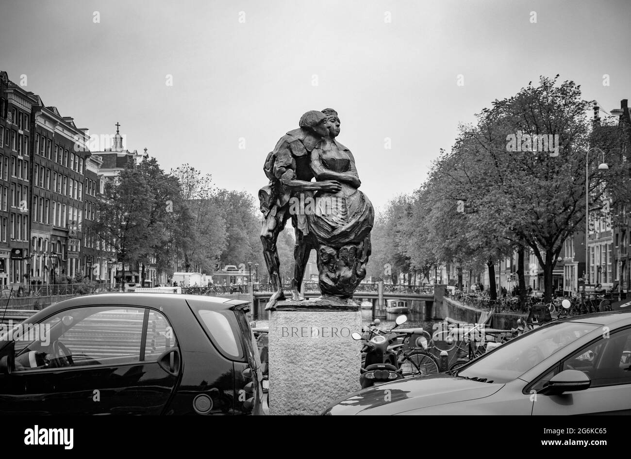 AMSTERDAM, NETHERLANDS. JUNE 06, 2021. Bredero Monument. Beautiful view of Amsterdam with typical dutch houses, bridges and chanel. Black and white ph Stock Photo