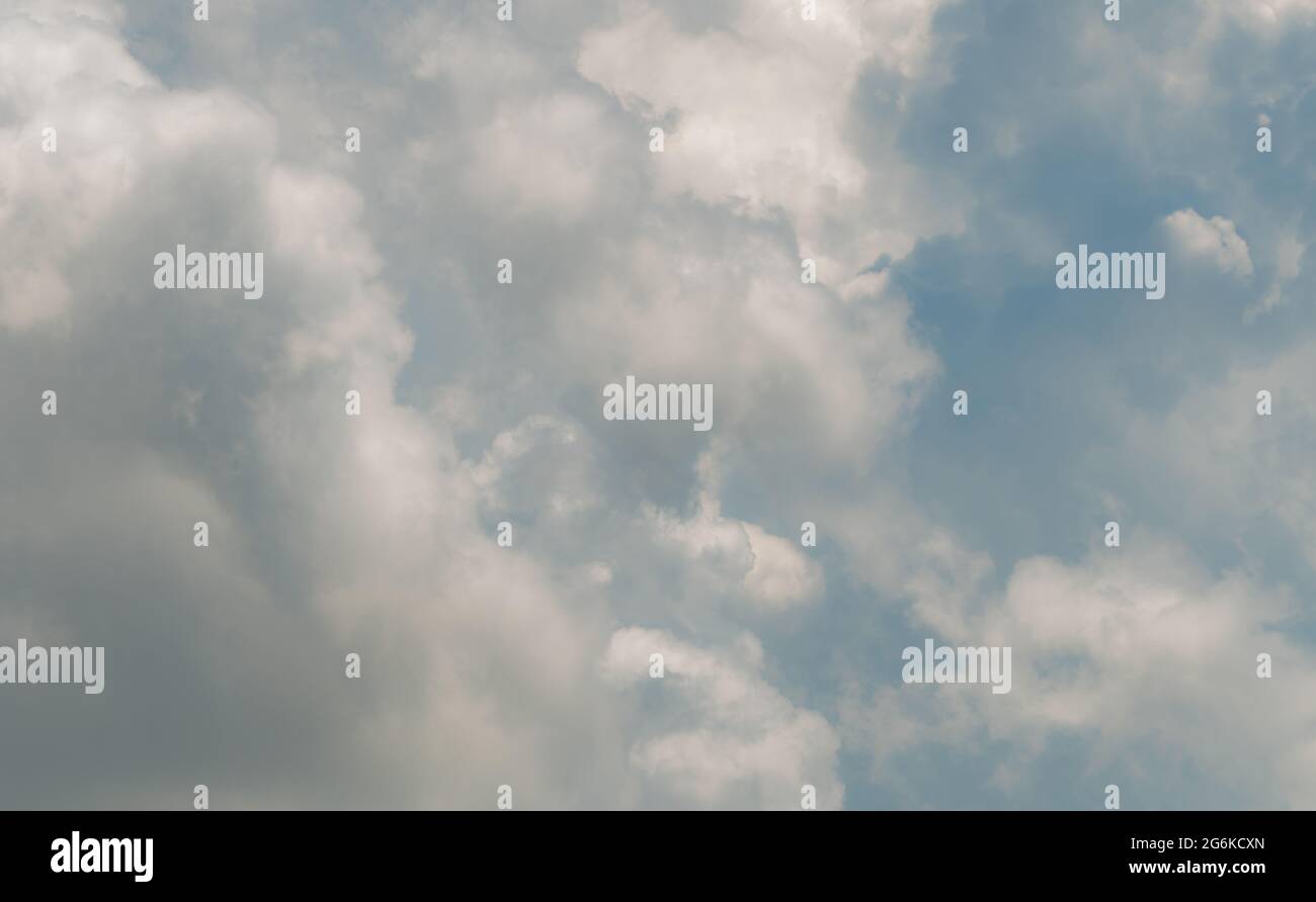 White fluffy clouds on blue sky. Soft-touch feeling like cotton. White puffy cloudscape. Beauty in nature. Close-up white cumulus clouds texture Stock Photo
