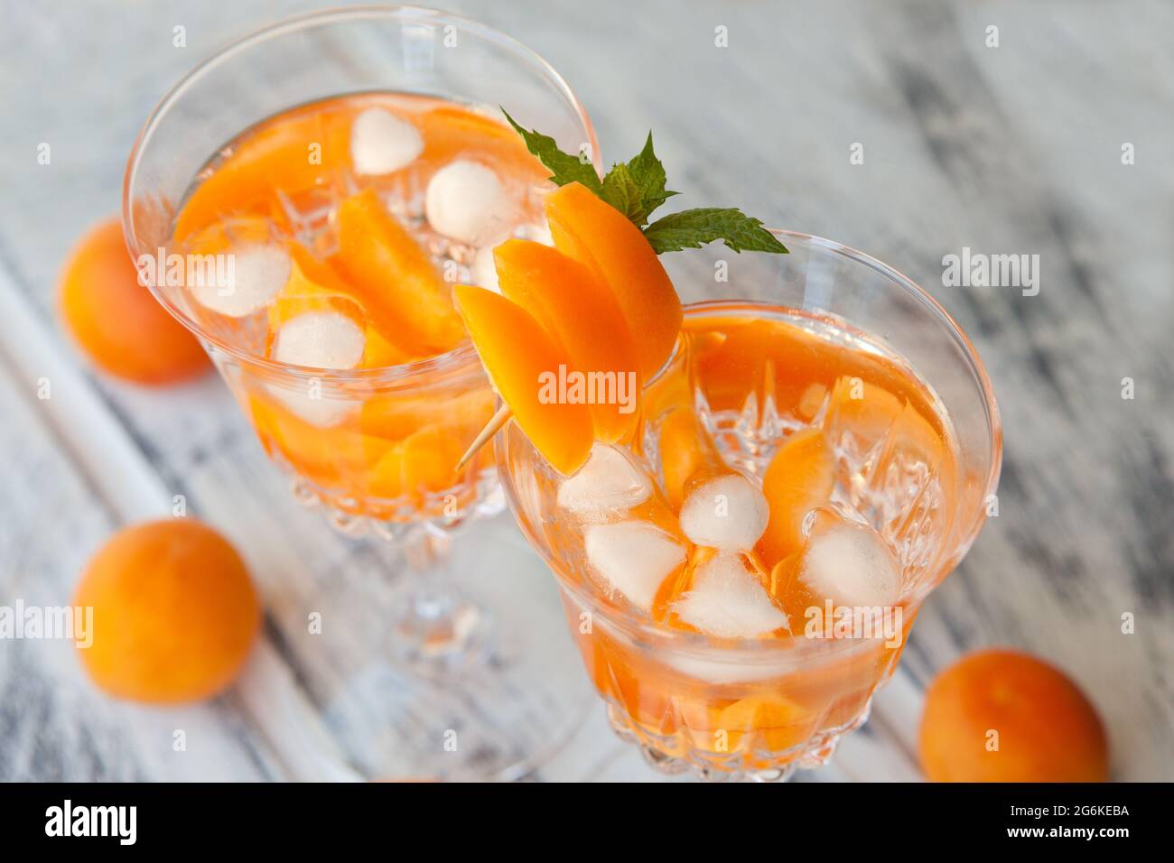Summer drinks, rosemary aprcot cocktails with ice in glasses