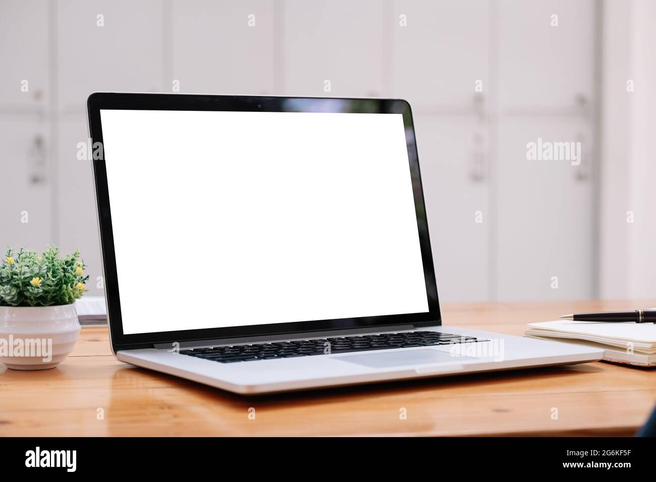 Laptop blank white screen on wood table at cafe shop, mockup, template for your text. Stock Photo