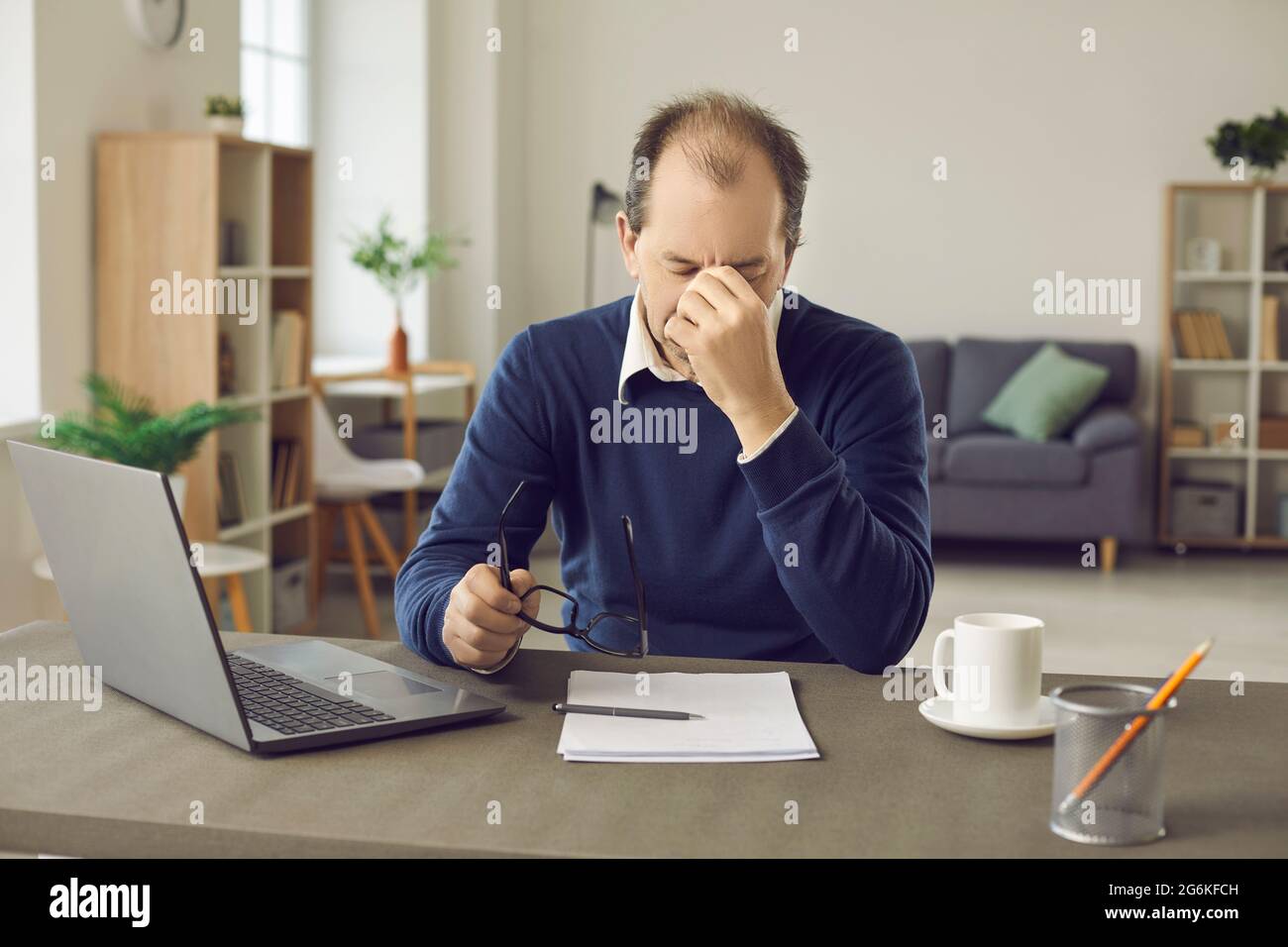 Senior business man who is tired from the workload suffers from