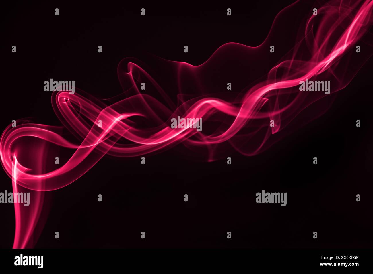 Pink smoke isolated on black background. Stock Photo