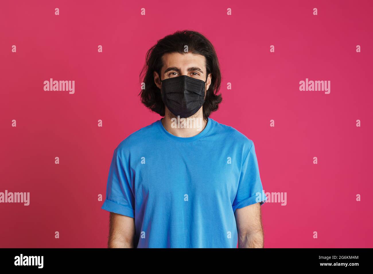 White brunette man in face mask posing and looking at camera isolated ...