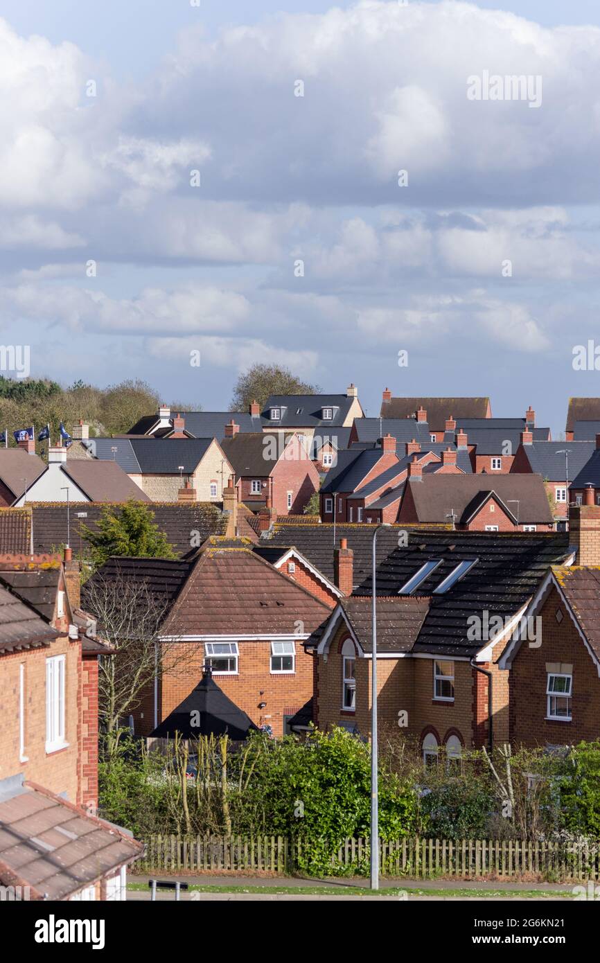 Roofline view of new housing, built between 1994 and 2021, on the outskirts of Wootton, Northampton, UK Stock Photo